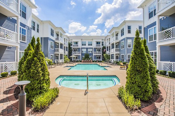 Resort-style pool with loungers at Everleigh Cool Springs Apartments, ideal for relaxation and recreation in a luxury setting