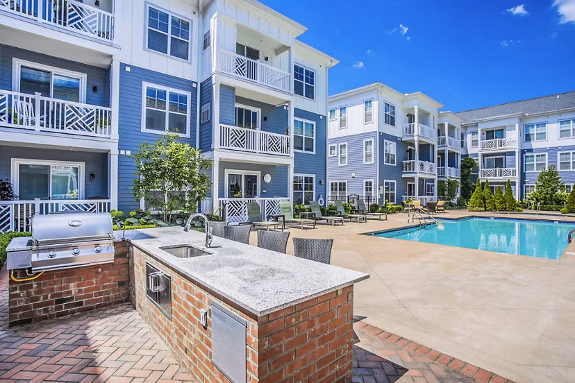Inviting grill area and poolside patio at Everleigh Cool Springs Apartments