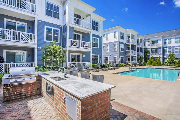 Inviting grill area and poolside patio at Everleigh Cool Springs Apartments