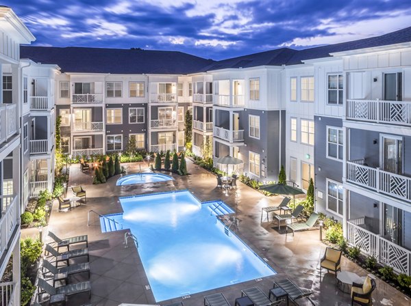 Luxury outdoor pool with lounge seating at Everleigh Cool Springs Apartments