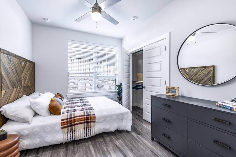 Bedroom with modern decor and large windows in Perch Apartments, Greystar luxury apartments showcasing elegance and comfort