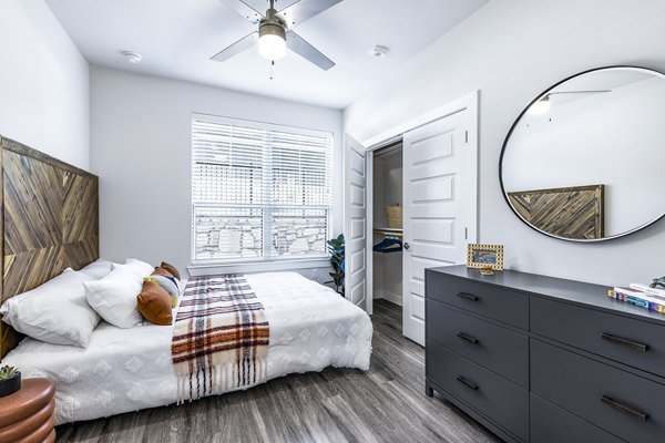 Bedroom with modern decor and large windows in Perch Apartments, Greystar luxury apartments showcasing elegance and comfort