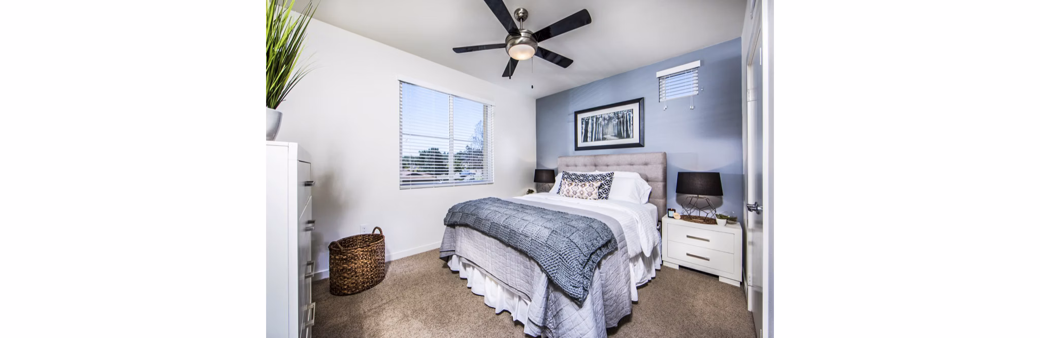 Haven76 Apartments: Modern bedroom with plush bedding and large window offering natural light