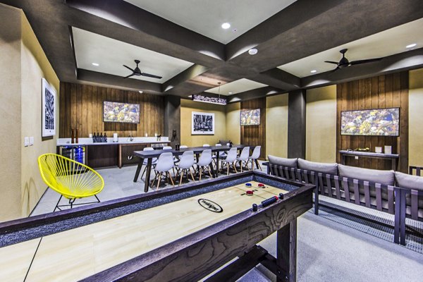 Clubhouse game room featuring pool table and lounge seating at Haven76 Apartments