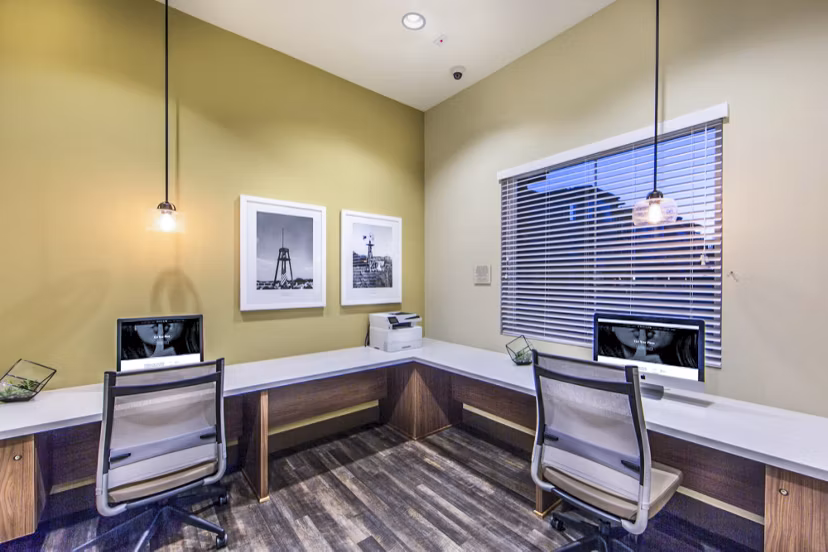 Modern business center with workstations and meeting space at Haven76 Apartments