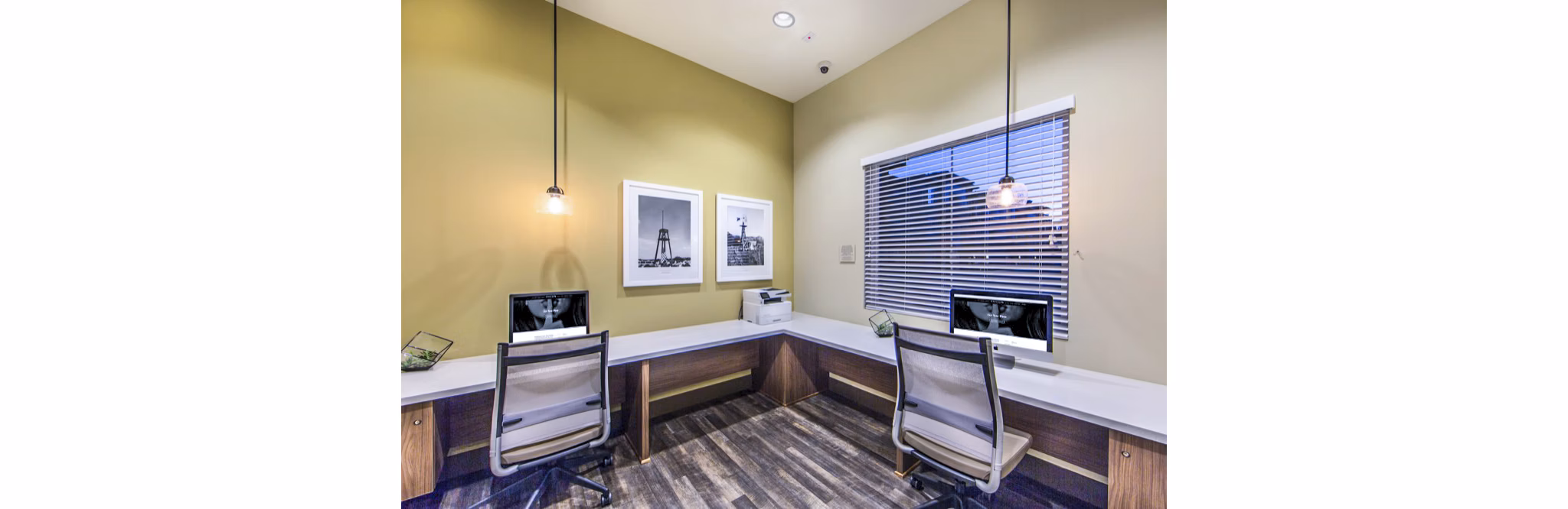 Modern business center with workstations and meeting space at Haven76 Apartments