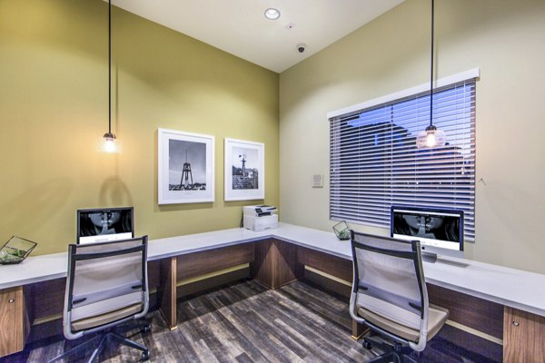 Modern business center with workstations and meeting space at Haven76 Apartments