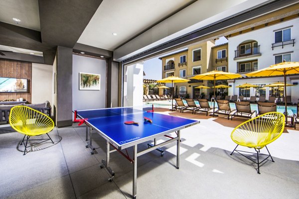Stylish clubhouse patio overlooking pool at Haven76 Apartments, a Greystar community