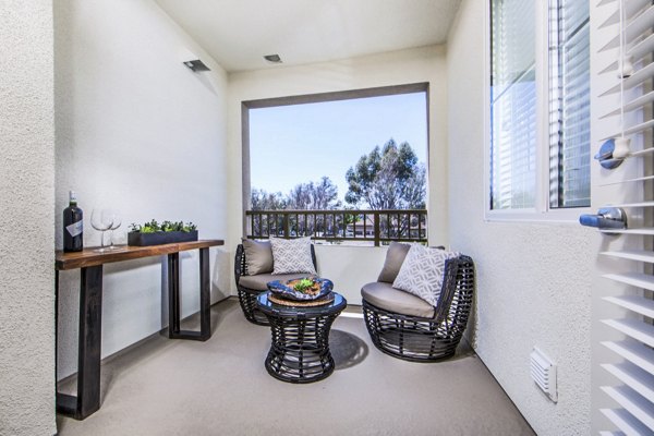 Haven76 Apartments: Chic patio with modern furnishings and lush landscaping