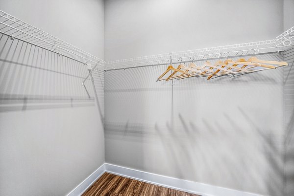 Walk-in bedroom closet with custom shelving in Beckon Collective Apartments