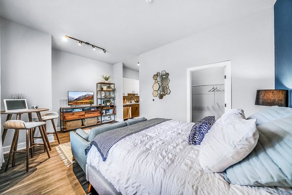Studio bedroom and living room featuring modern decor at Beckon Collective Apartments