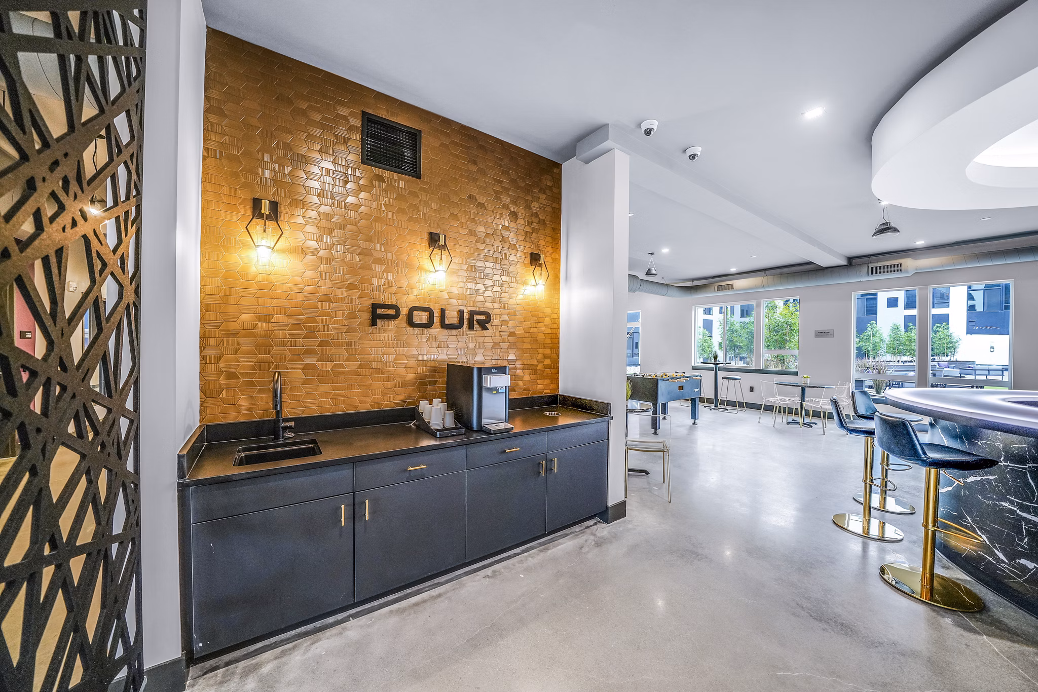 Clubhouse featuring modern decor and lounge seating at Beckon Collective Apartments