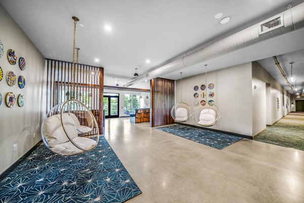 Clubhouse lobby with modern seating and dÃ©cor at Beckon Collective Apartments