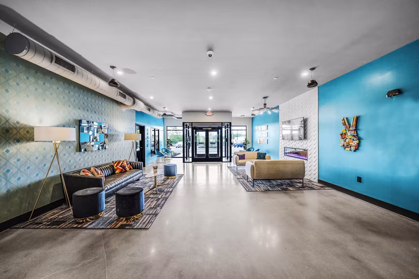 Modern clubhouse/lobby with contemporary furnishings at Beckon Collective Apartments, perfect for social gatherings and relaxation