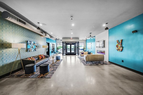 Modern clubhouse/lobby with contemporary furnishings at Beckon Collective Apartments, perfect for social gatherings and relaxation