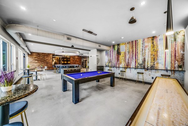 Game room featuring pool table and modern seating at Beckon Collective Apartments, perfect for socializing in luxury settings