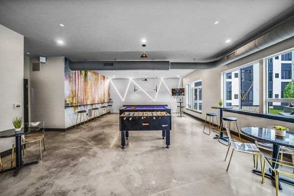 Game room featuring pool table and lounge seating in Beckon Collective Apartments