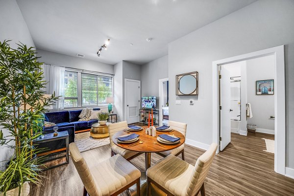 Dining room with elegant lighting and modern decor at Beckon Collective Apartments
