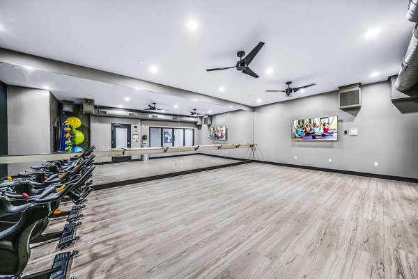 Yoga and spin studio with modern equipment at Beckon Collective Apartments, offering a space for fitness and wellness enthusiasts