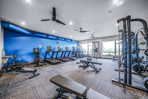 State-of-the-art fitness center with various equipment at Beckon Collective Apartments for an active lifestyle.