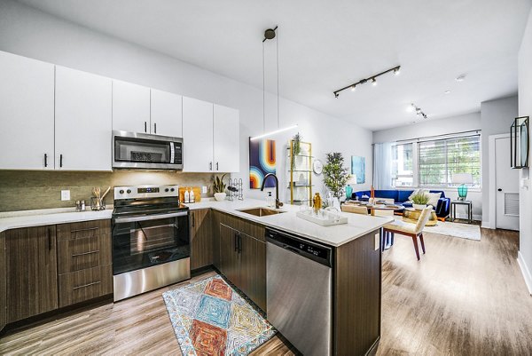 Modern kitchen featuring stainless steel appliances at Beckon Collective Apartments