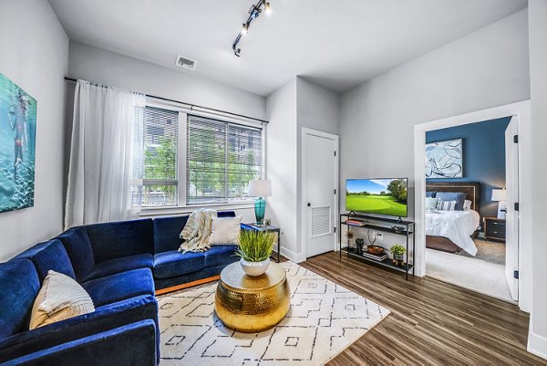 Spacious living room with modern furnishings at Beckon Collective Apartments
