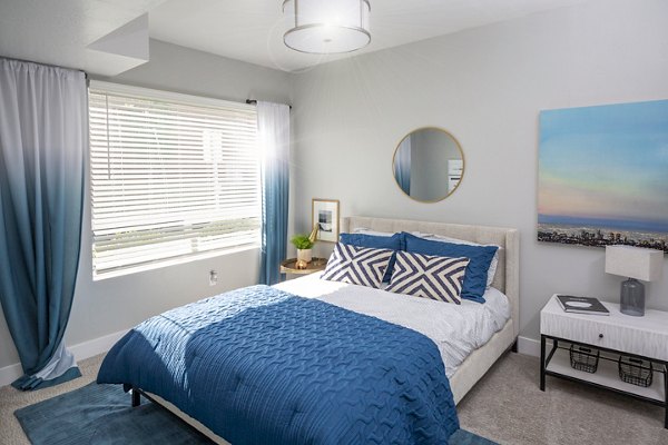 Bedroom featuring modern decor and ample natural light in 644 City Station Apartments, a luxury property offering a stylish retreat in the city