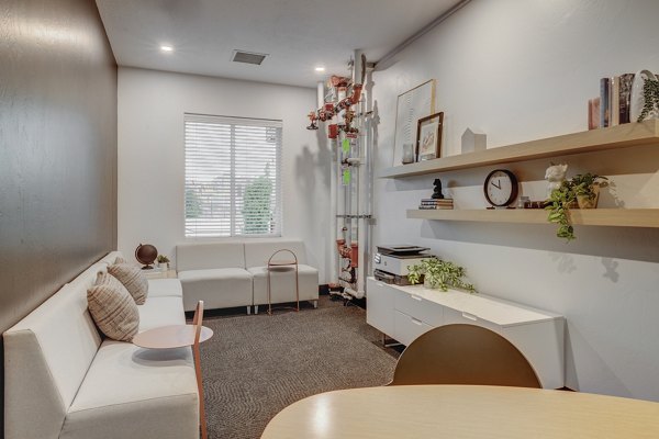 Modern clubhouse with stylish seating and game areas at 644 City Station Apartments