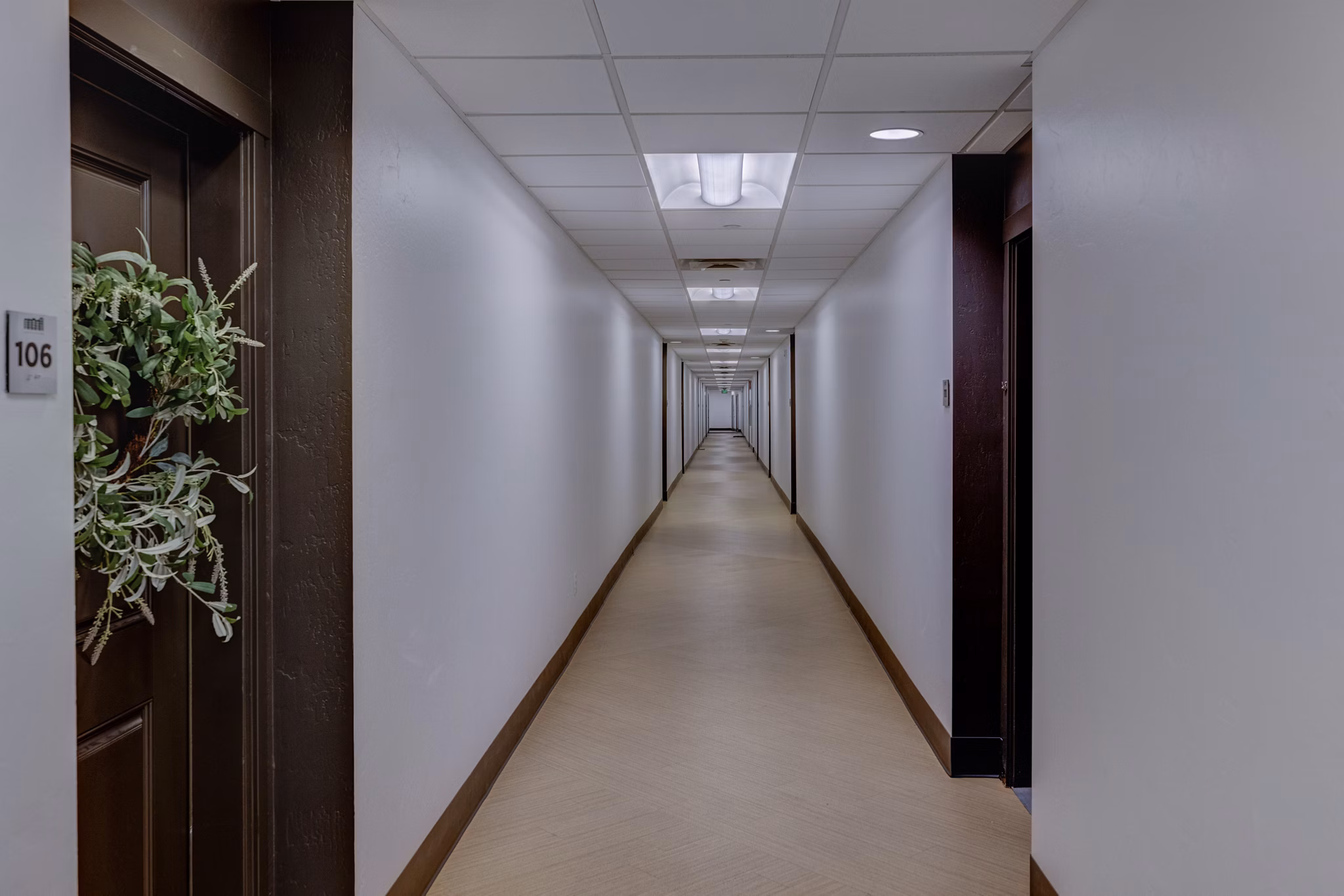 Hallway with modern lighting and artwork at 644 City Station Apartments