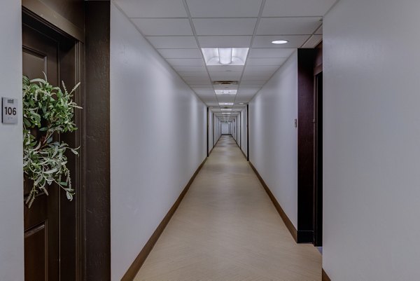 Hallway with modern lighting and artwork at 644 City Station Apartments