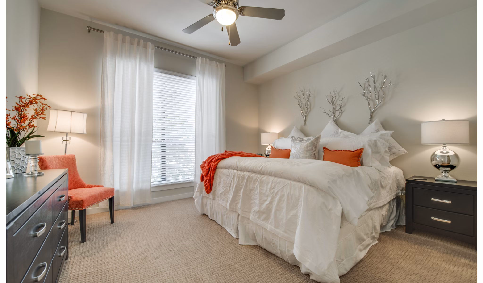 Modern bedroom with large windows at 2900 West Dallas Apartments, offering luxury living with stylish furnishings and ample natural light