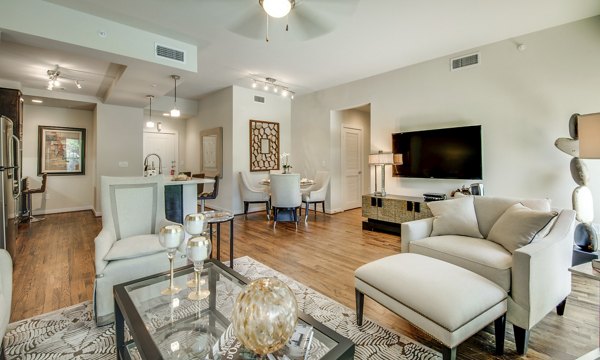 Spacious living room featuring modern decor and large windows at 2900 West Dallas Apartments in Houston