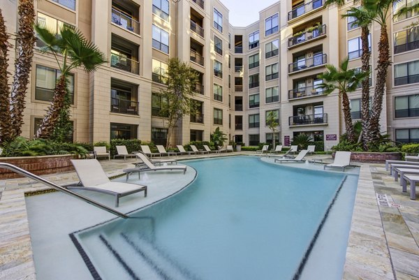 Resort-style pool area at 2900 West Dallas Apartments with loungers and landscaped surroundings