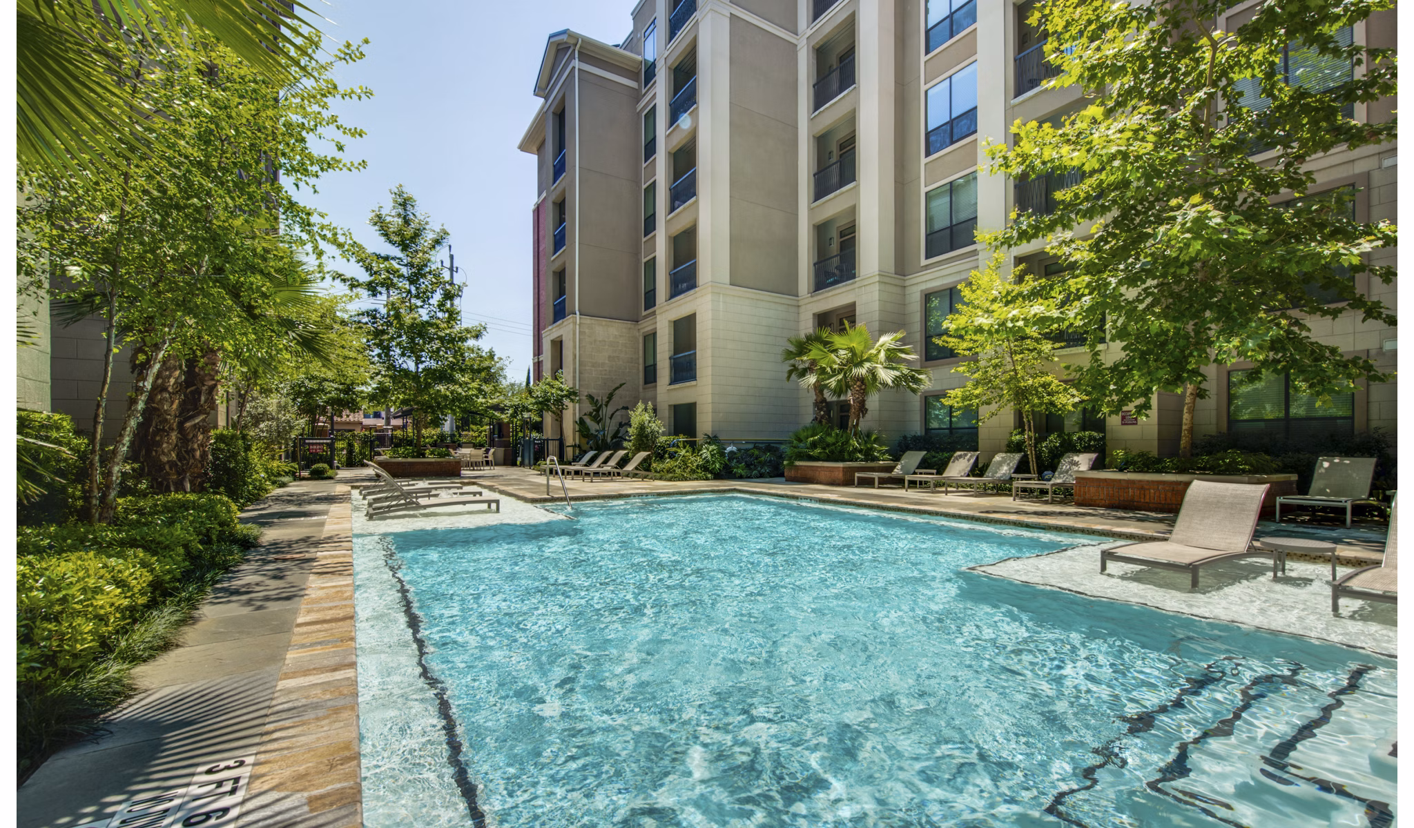 Relaxing pool area with lounge chairs at 2900 West Dallas Apartments, ideal for luxury living and leisure
