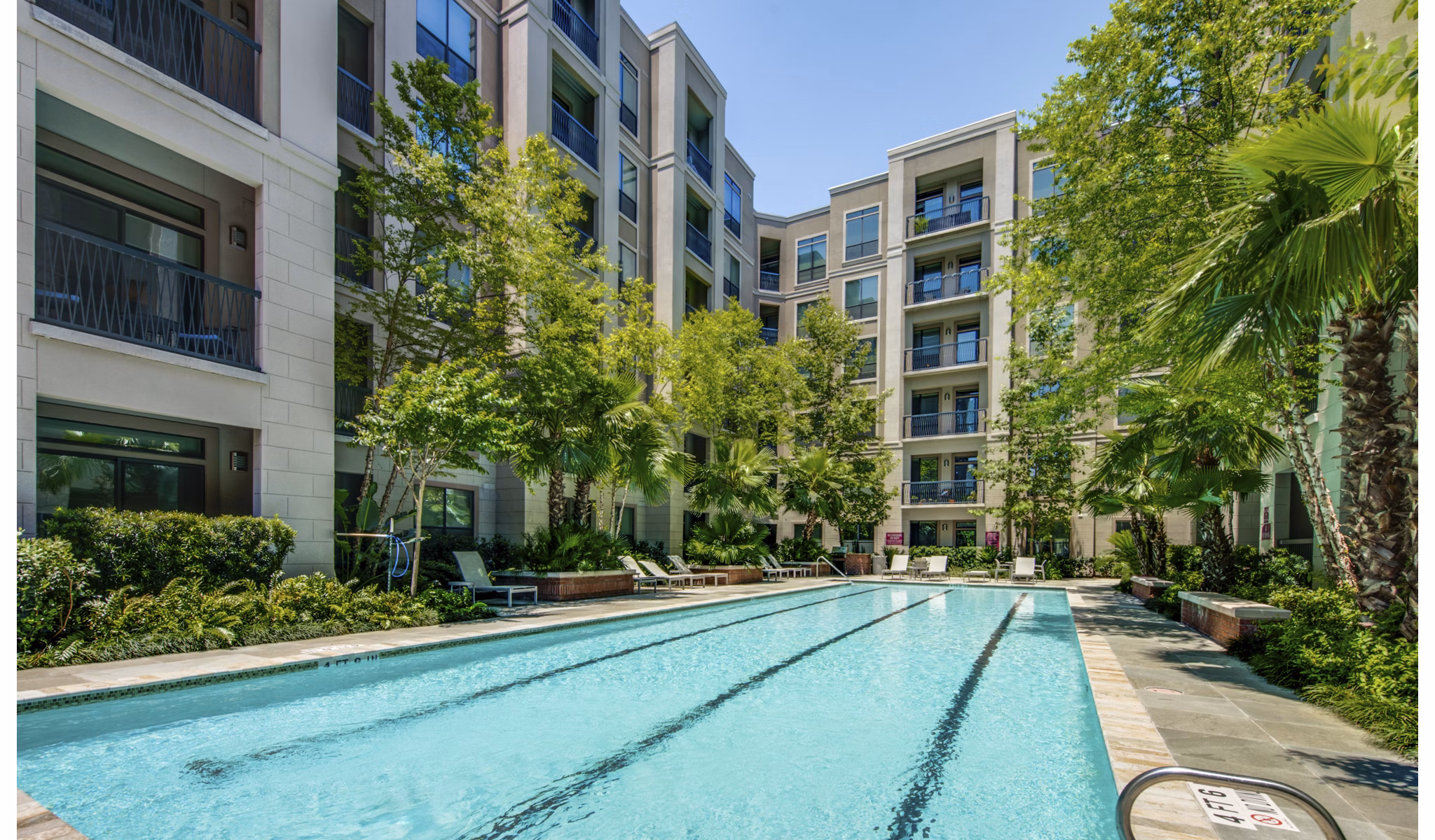 Luxury pool area with sun loungers at 2900 West Dallas Apartments in Houston, perfect for relaxation and leisure