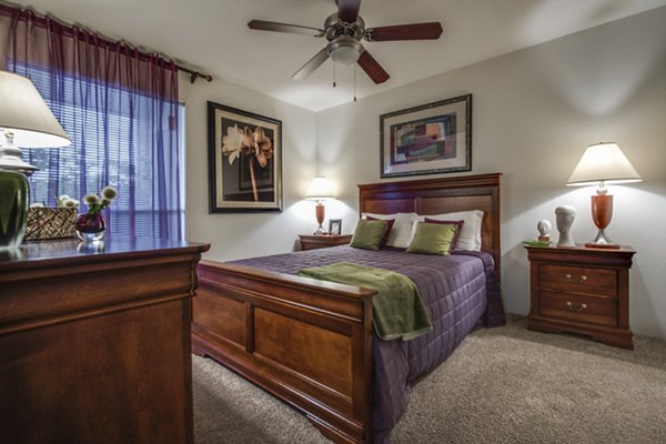 Spacious bedroom with modern decor at The Bellfort Apartments, offering luxury living with elegant design elements and ample natural light