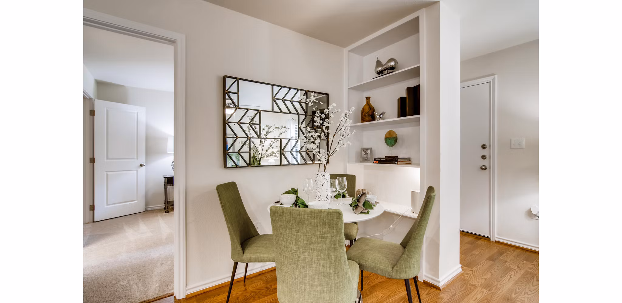 Dining area with modern furnishings at The Bellfort Apartments featuring open layout and stylish accents