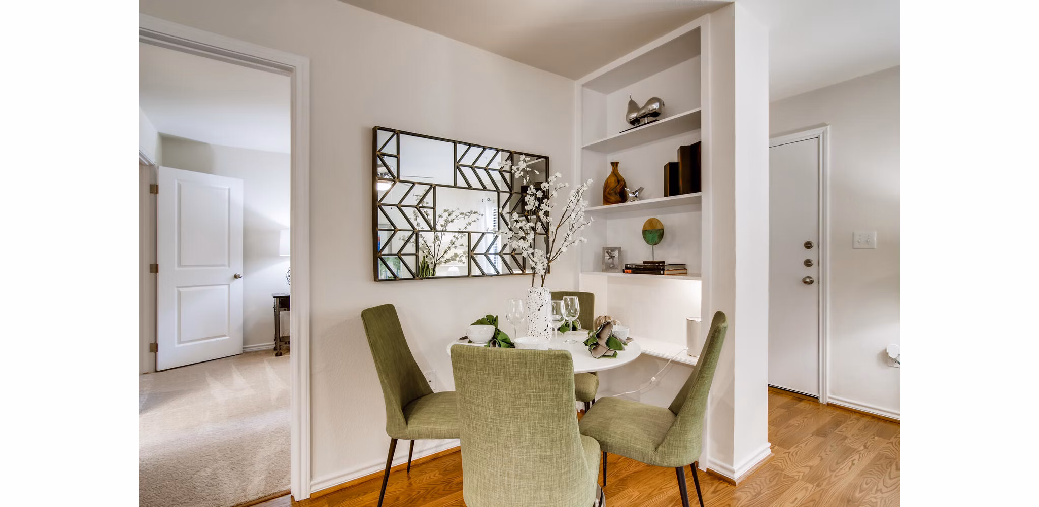 Dining area with modern furnishings at The Bellfort Apartments featuring open layout and stylish accents