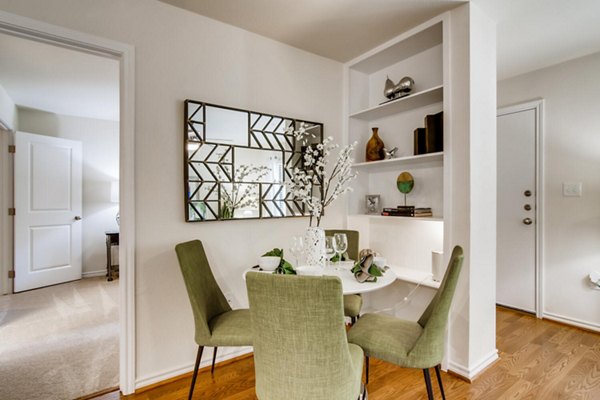 Dining area with modern furnishings at The Bellfort Apartments featuring open layout and stylish accents