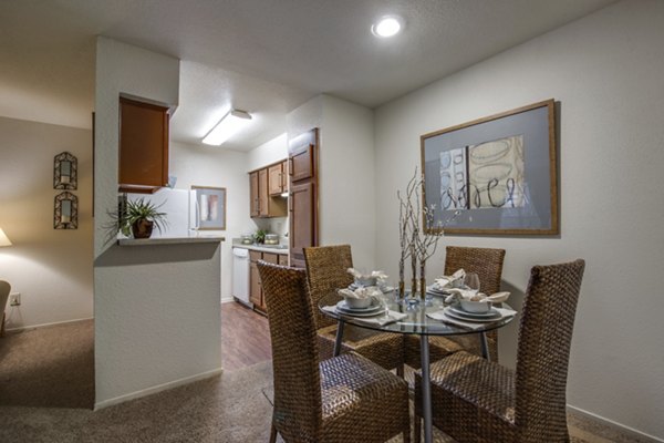 The Bellfort Apartments: Contemporary dining area with sleek furniture and modern lighting