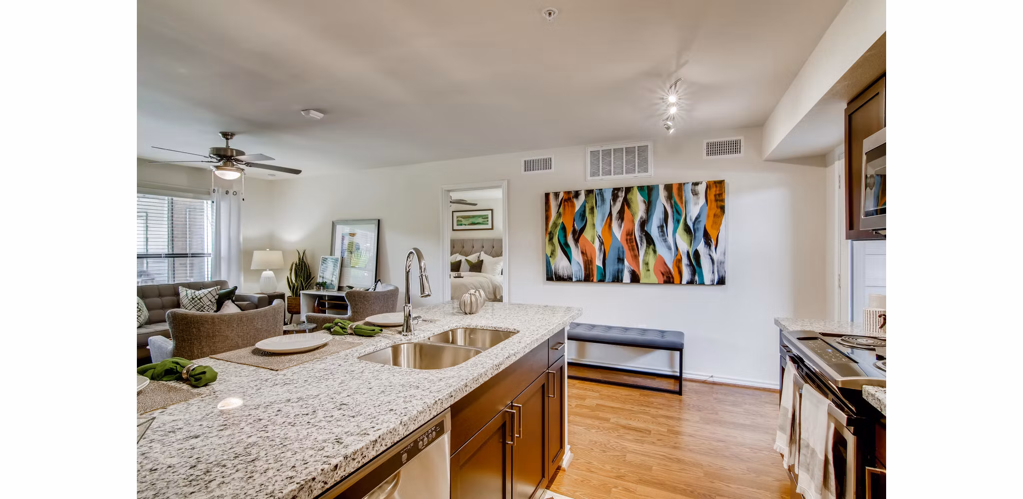 Modern kitchen with stainless steel appliances in The Bellfort Apartments