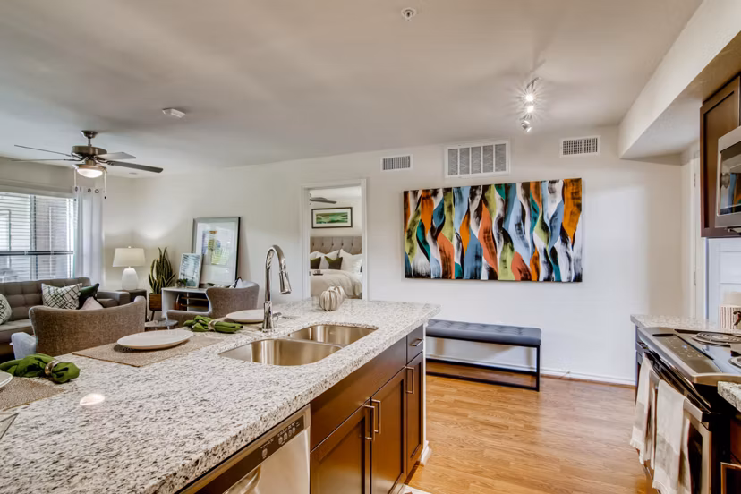 Modern kitchen with stainless steel appliances in The Bellfort Apartments