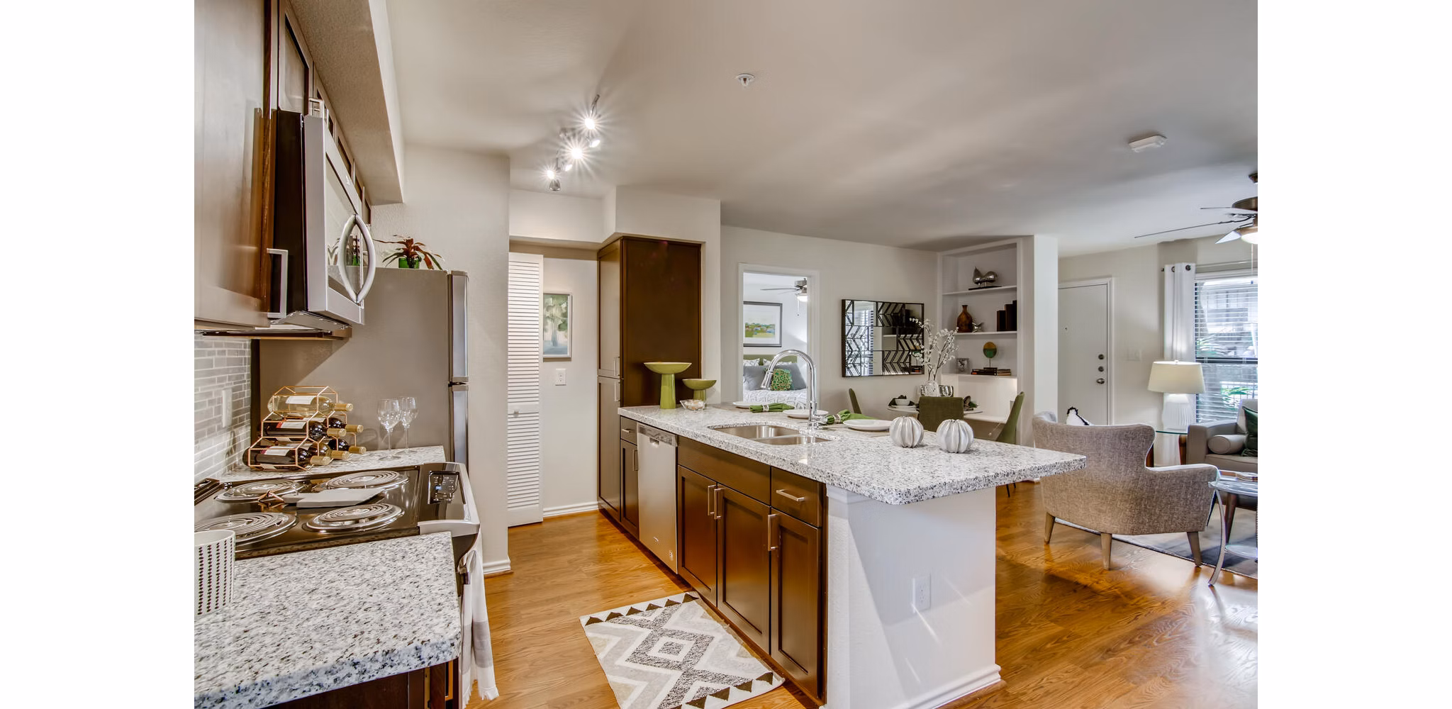 Modern kitchen with stainless steel appliances at The Bellfort Apartments