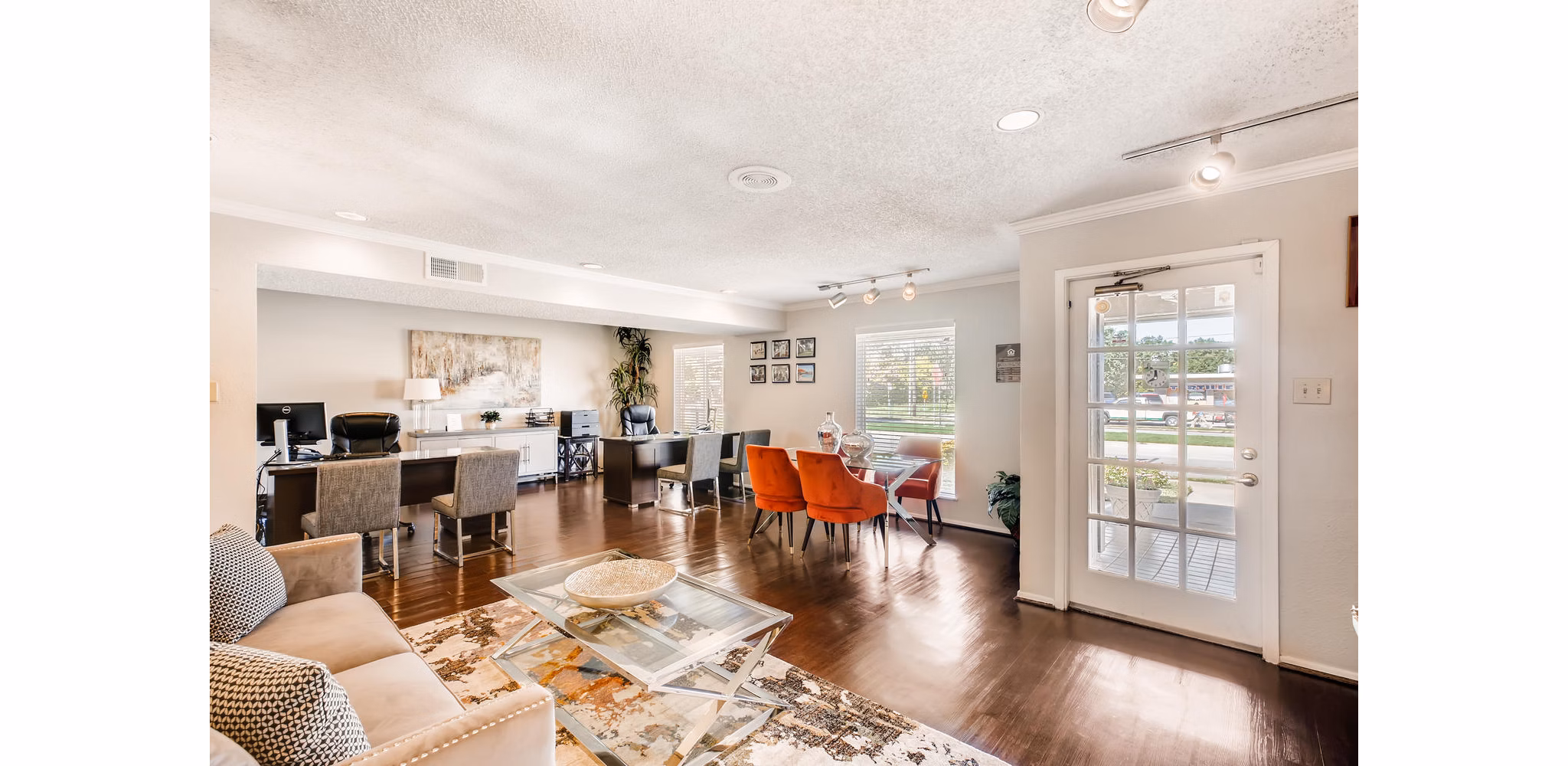 Spacious living room featuring elegant decor and ample natural light at The Bellfort Apartments