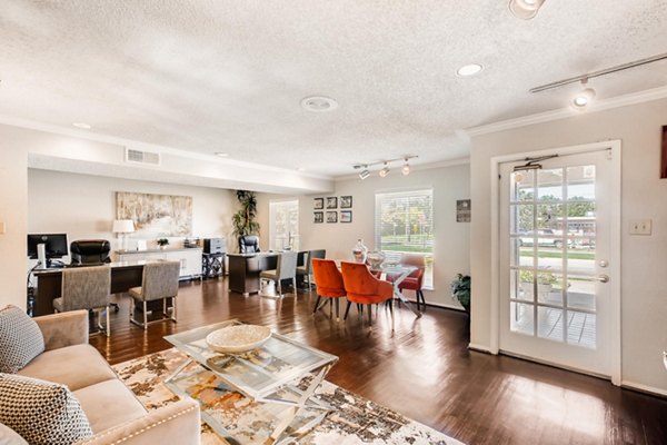 Spacious living room featuring elegant decor and ample natural light at The Bellfort Apartments