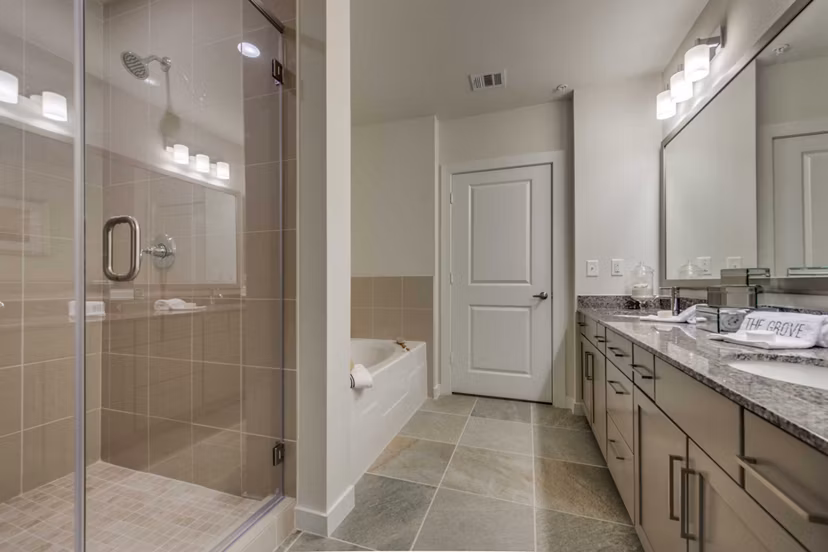 Bathroom with sleek fixtures and modern design at Grove at Wilcrest Apartments