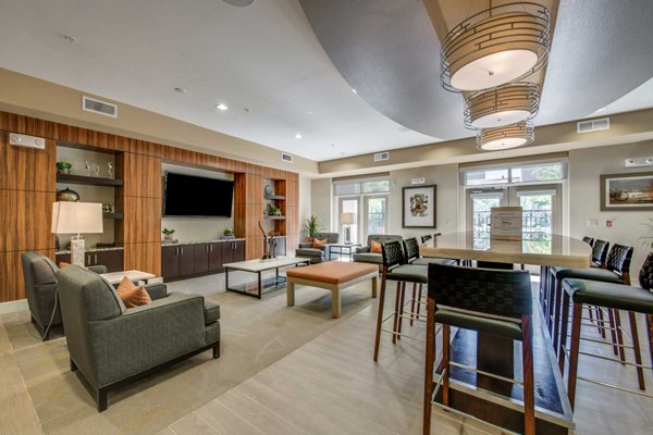 Clubhouse featuring modern seating and lounge area at Grove at Wilcrest Apartments