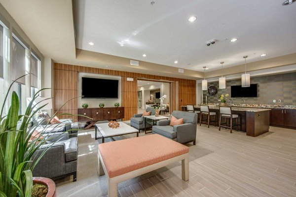 Grove at Wilcrest Apartments: Modern clubhouse featuring luxurious seating and decor