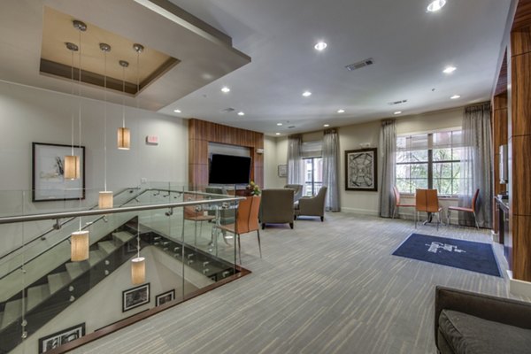 Clubhouse featuring modern lounge spaces at Grove at Wilcrest Apartments