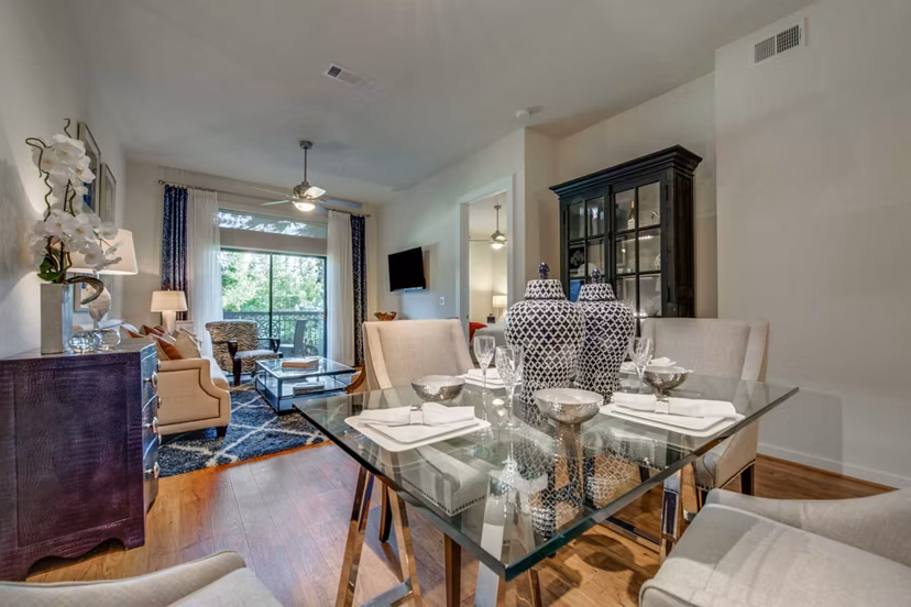 Dining area with contemporary design and elegant lighting in Grove at Wilcrest Apartments, showcasing luxury living options